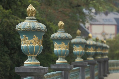 Balustrade with row of lidded vases, lidded vase, vase, balustrade, golden, depth of field, blur,