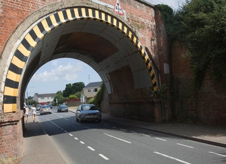 Warning paint over arch of low road bridge in Lawford, near Manningtree, Essex, England, United