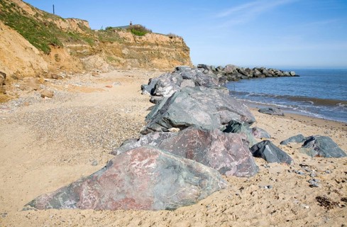 Rock armour used to defend soft crumbling cliffs, Happisburgh, Norfolk, England, United Kingdom,