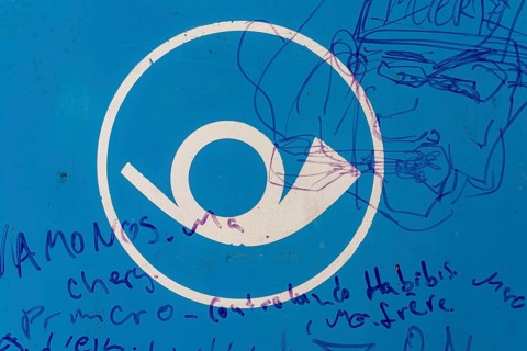 Post horn, horn of the post office, scribbled drawings and writing on a blue surface, Germany,