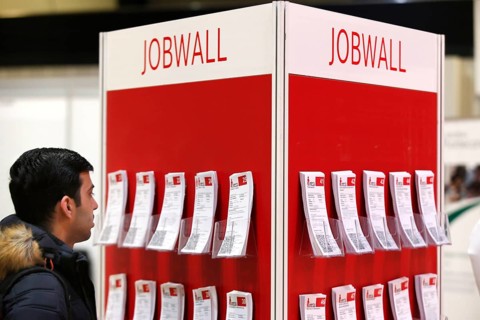 Job offers are posted on a job wall at the job exchange for refugees and foreign citizens in