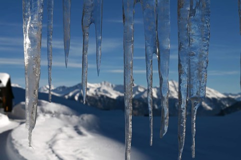 Icicle on a house in the Beverin nature park Park, Graubuenden, Switzerland, Europe