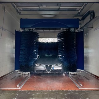 View of a car wash, Alfa Romeo being washed in a car wash with textile brushes, Germany, Europe