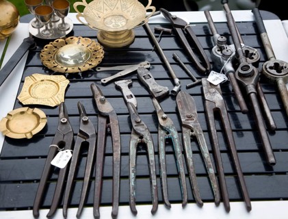 Old metal tools on display at a car boot sale, UK