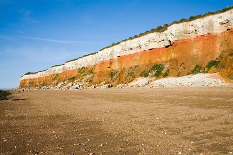 Chalk, red chalk and carstone form striped cliffs of white, red and orange at Hunstanton, Norfolk,