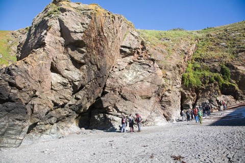 Student group of geologists on a fieldtrip at Polpeor Cove, Lizard Point, Cornwall, England, United