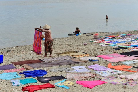 Washing clothes in the Irrawaddy, Myanmar, Asia