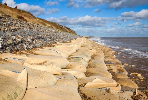 Coastal defences normally covered by shingle exposed by winter storms at Thorpeness, Suffolk,