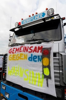 Together against the madness of traffic lights, banner on a truck, farmers' protests, demonstration