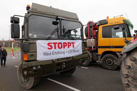 Banners against toll increase and CO2 tax on a truck, farmers' protests, demonstration against