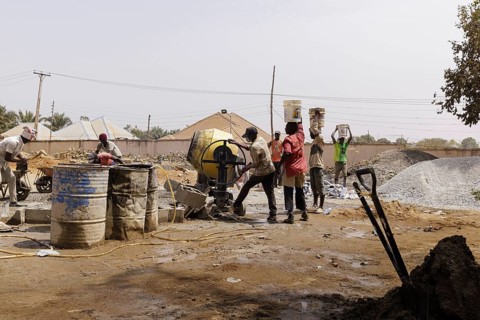 Young men working on a construction site in Nigeria, 06.02.2024