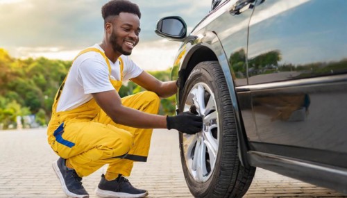 AI generated, A mechanic changes the tyres on a customer's car, Tyre fitting