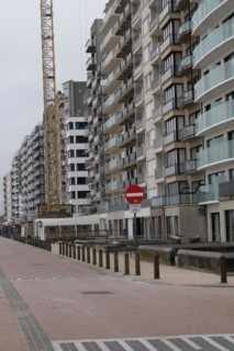 A street view with houses and a stop sign in an urban environment, Blankenberge, Flanders, Belgium,