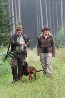 Huntsman and huntress, accompanied by hunting dog Bavarian Mountain Hound, Allgaeu, Bavaria,