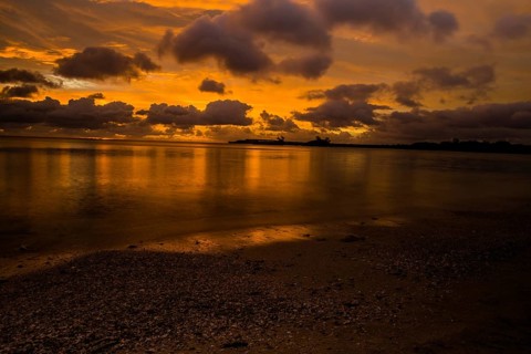 Beautiful sunset over ocean water taken from a beach in Guam