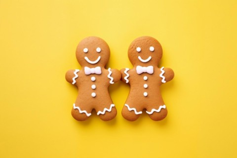Pair of cute gingerbread cookie men on yellow background. KI generiert, generiert AI generated