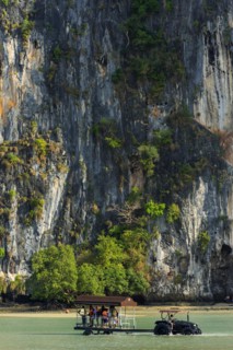 Tractor for transporting tourists in front of limestone rocks at Railay Beach, transport,
