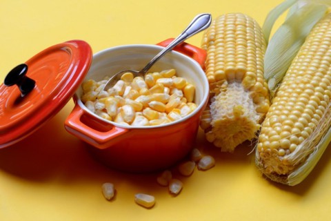 Fresh maize kernels in pots and cobs, corn (Zea mays)