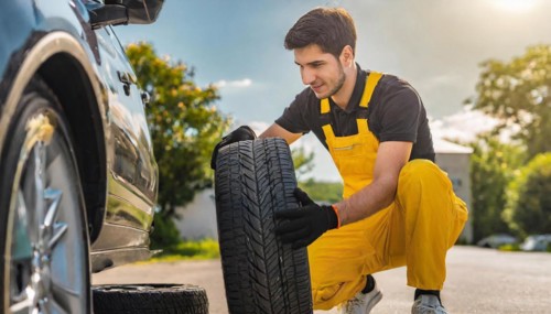 AI generated, A mechanic changes the tyres on a customer's car, Tyre fitting