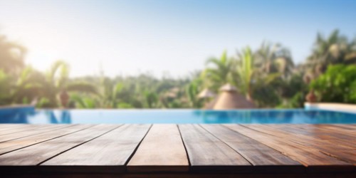 Wooden empty table with tropical resort swimming pool and trees in blurry background. KI generiert,