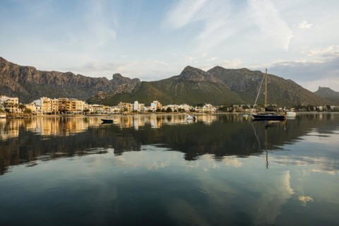 Village by the sea and mountains at sunrise, Port de Pollenca, Serra de Tramuntana, Majorca,