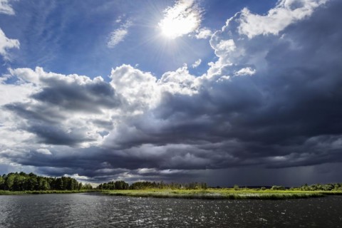 Dramatic changeable weather on the lake with cloudy sky, sun, cloud, light, light mood, atmosphere,