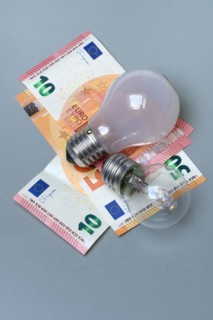 Banknotes and light bulbs, electricity costs