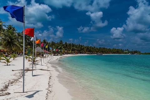 White sand beach with many flags, Bangaram island, Lakshadweep archipelago, Union territory of
