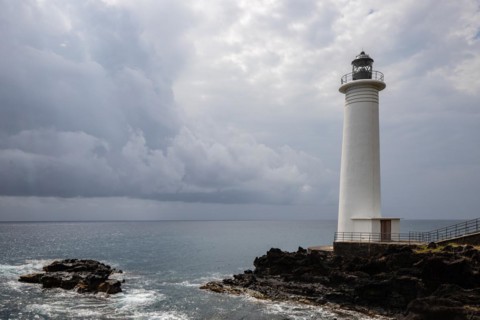 White lighthouse on a steep coast. Dramatic clouds with a view of the sea, pure Caribbean at Le
