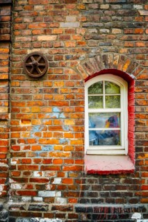 Window in brick house of Nikiszowiec, mining district of Katowice, Poland, Europe