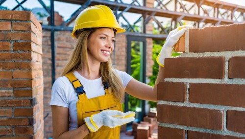 AI generated, A female bricklayer inspects a brick wall, 30, 35, years