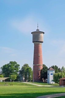 Brick water tower stands on a green lawn under a clear blue sky, Ladenburg, Baden-Wuerttemberg,