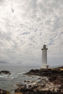 White lighthouse on a steep coast. Dramatic clouds with a view of the sea, pure Caribbean at Le