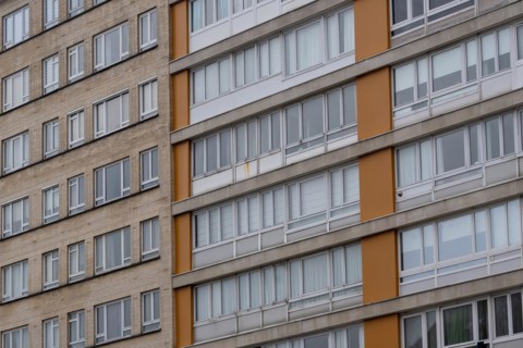Urban apartment complex with orange-coloured balconies and many windows, Blankenberge, Flanders,