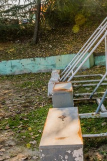 Neglected and rusty sports seating with scattered fallen leaves, in South Korea
