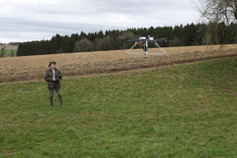 Hunter observes and controls flying drone during a hare (Lepus europaeus) census, Lower Austria,