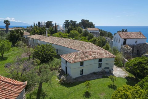 Mediterranean architecture with churches and houses, surrounded by trees under a blue sky, view of