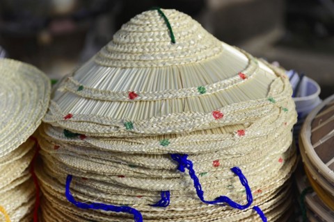 Pile of traditional Asian conical hats, decorated with various patterns, Inle Lake, Myanmar, Asia