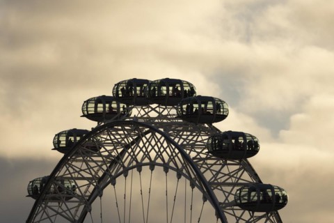 London Eye or Millennium Wheel tourist observation wheel close up of pods at sunset, City of
