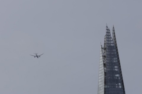 Airbus A319-100 aircraft of British airways in flight over The Shard city skyscraper building,