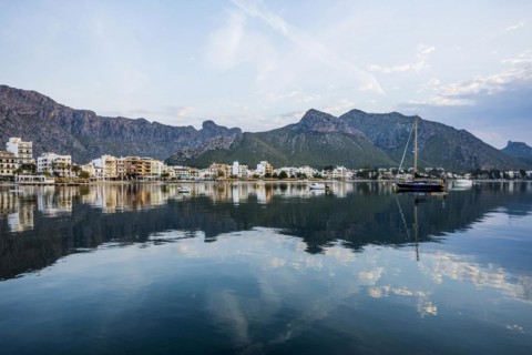 Village by the sea and mountains at sunrise, Port de Pollenca, Serra de Tramuntana, Majorca,
