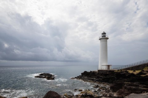 White lighthouse on a steep coast. Dramatic clouds with a view of the sea, pure Caribbean at Le