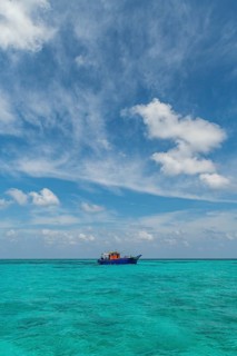 Little boat in the turquoise waters of Agatti Island, Lakshadweep archipelago, Union territory of
