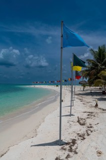 White sand beach with many flags, Bangaram island, Lakshadweep archipelago, Union territory of