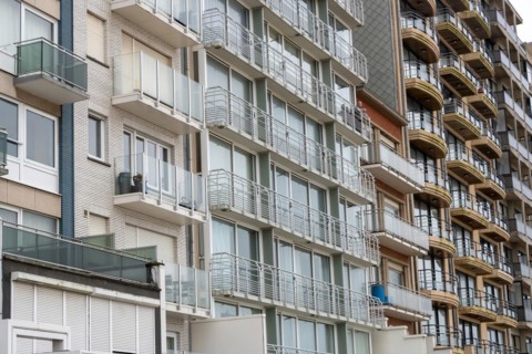 Stack of flat balconies with glass railings on a multi-storey building, Blankenberge, Flanders,