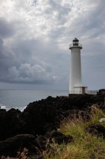 White lighthouse on a steep coast. Dramatic clouds with a view of the sea, pure Caribbean at Le