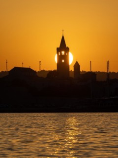 Golden evening light at sunset, silhouette of the church towers of Rab, town of Rab, island of Rab,
