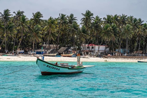 Little boats before a palm fringed white sand beach, Agatti Island, Lakshadweep archipelago, Union
