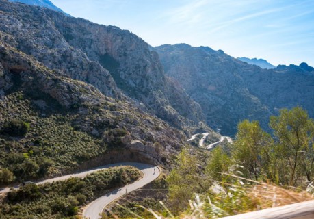 Mountain landscape with winding mountain road from Sa Calobra to Torrent de Pareis, cars and a