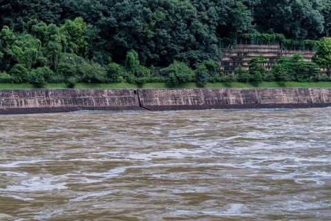 Water rushing rapidly down a river swelled my torrential monsoon rainfall in Daejeon South Korea